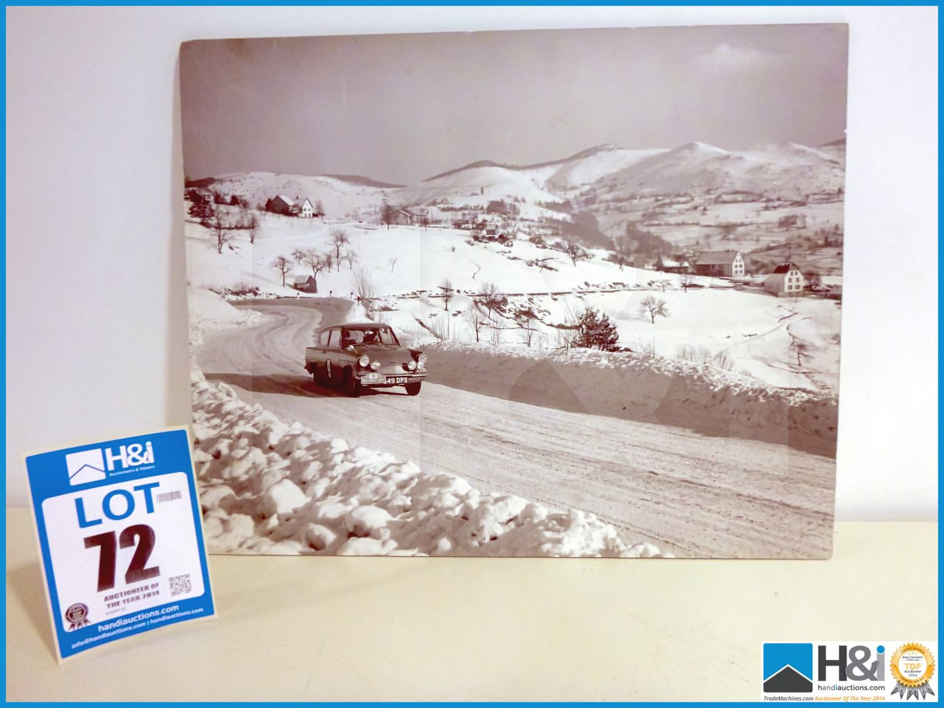 Unframed, board backed black and white photo print of Ford Anglia on Monte Carlo Rally. Appx 22in x