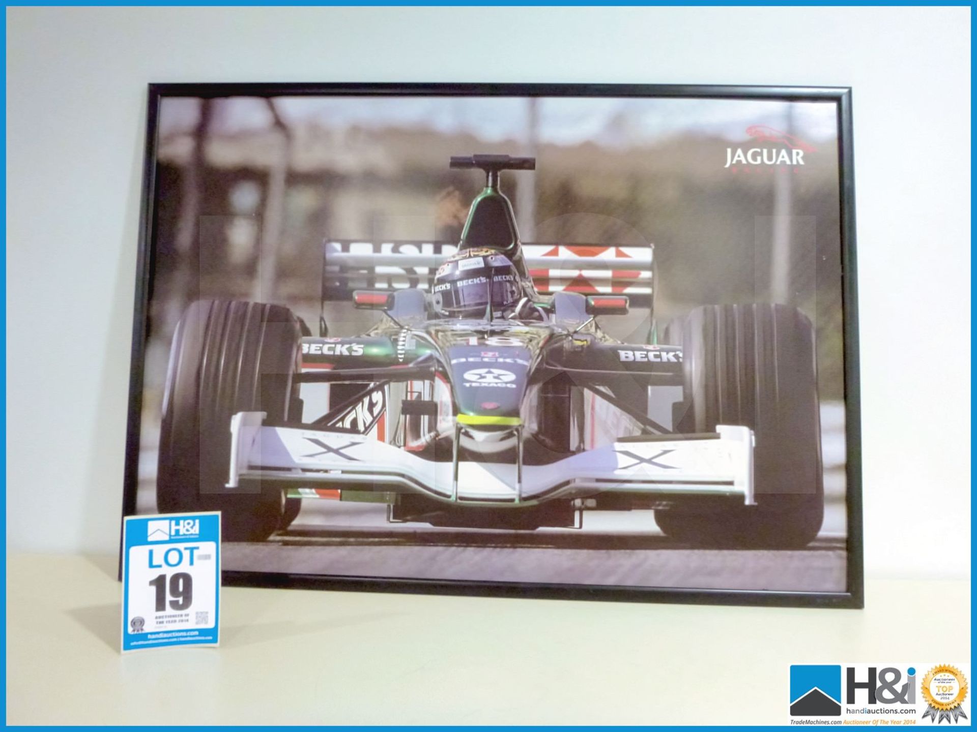 Framed picture of Jaguar Cosworth Powered F1 car. Eddie Irvine. Approx 41in X 29in -- MC:N/A CILN:N/