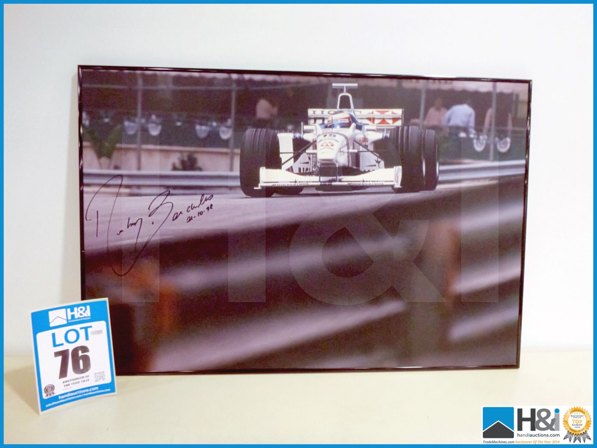 Framed photograph of Rubens Barrichello racing at what is believed to be Monaco, dated 21/10/98 sign