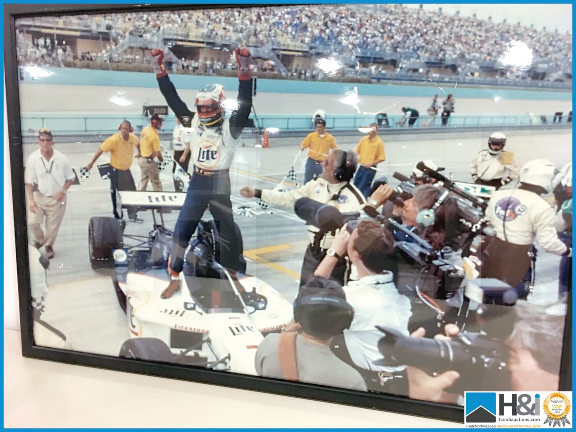 Framed photograph of Indycar race winner. Picture has minor damage. Appx 27in x 18in. From the Coswo - Image 2 of 3