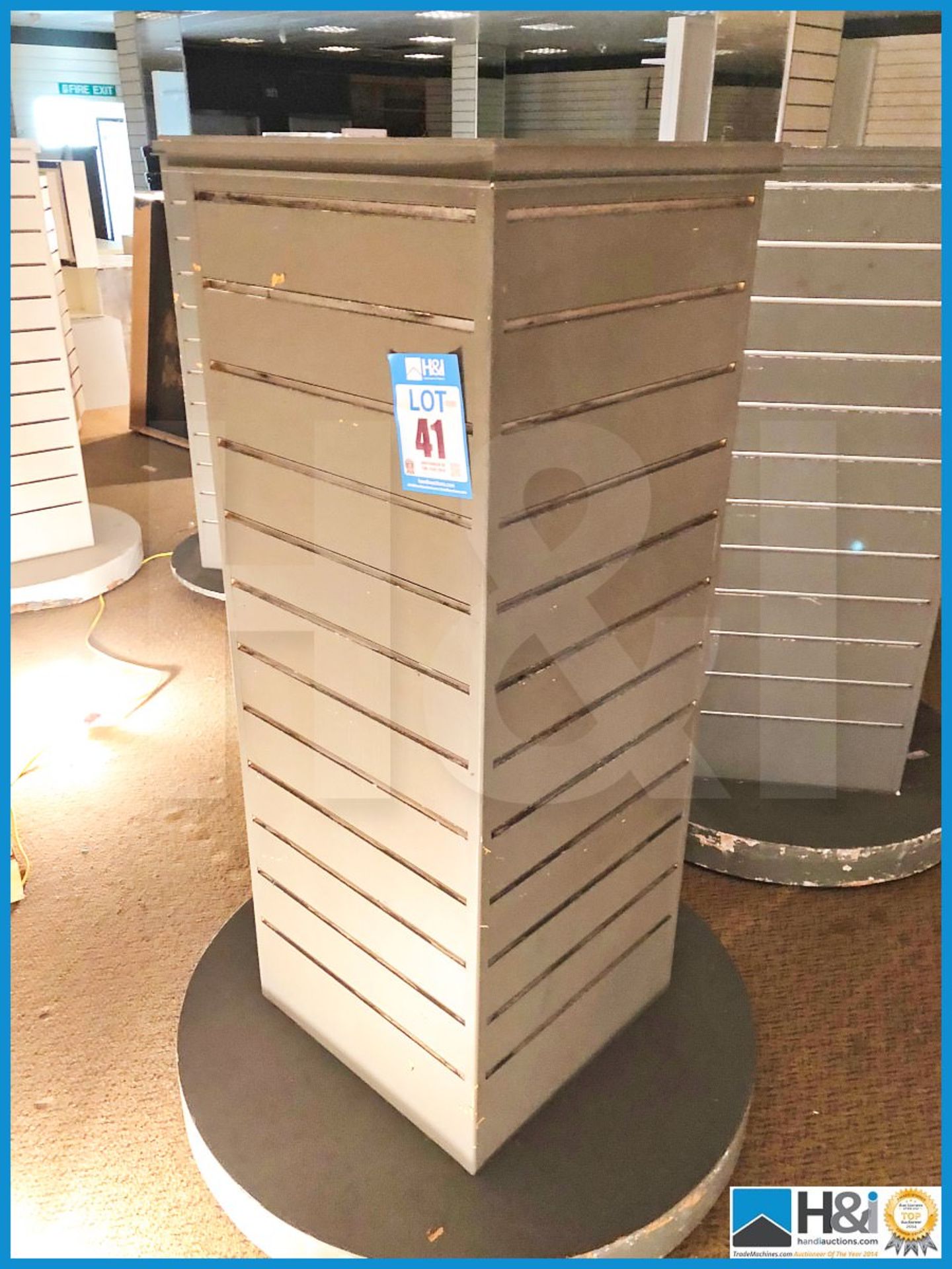 Five free standing four sided slat wall display stands.