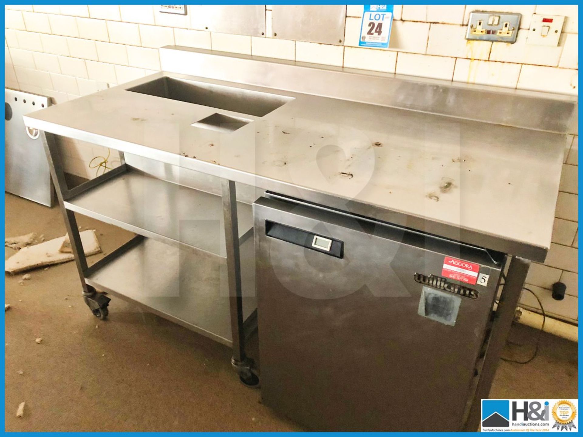 Stainless steel food preparation bench on wheels 1600mm long X 760mm deep. Fridge not included.