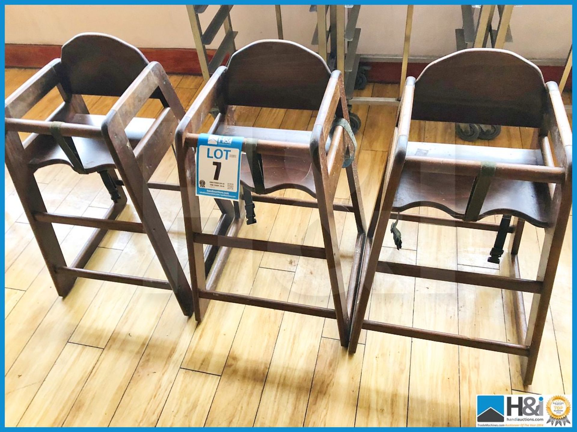 Three wooden highchairs.