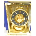 A Jaeger Le Coultre Atmos clock in a brass and glass case (front door missing), complete with