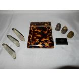 A Victorian tortoiseshell covered visiting card case, three fruit knives with mother of pearl