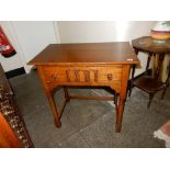 A reproduction oak sidetable fitted frieze rawer, on turned legs and stretchers - 30in. wide