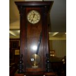 A regulator wall clock with cream enamel dial, in a walnut case with glass door and sides (af)