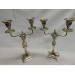 A pair of Victorian silver twin branch candelabra with fluted urn form decoration, on tapering