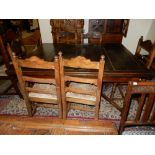 An oak drawleaf dining table on barley twist legs united by shaped stretchers - 54in. x 42in. and