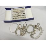 A box containing silver and other rings, earrings and bracelets