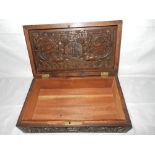 A Chinese rosewood box with all over carved decoration of dragons, mons and flowers - 13in. x 7 1/