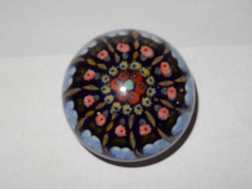 A French style paperweight, blue with pink, red yellow and blue floral and twist canes - 3in. dia.