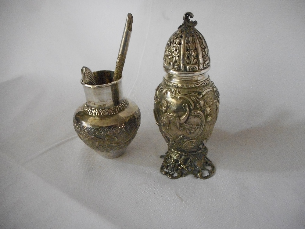 A Victorian silver sugar castor with repousse decoration of figures and leaf scrolls, on pierced