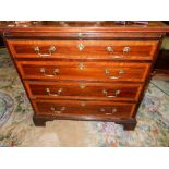 A Georgian mahogany and satinwood inlaid chest with shell paterae, brushing slide, four wide