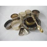 Seven silver napkin rings various, a pair of Victorian silver sugar tongs, a Continental spoon