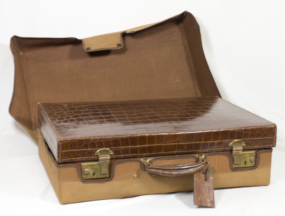 A brown crocodile skin suitcase by Cleghorn of Edinburgh, the interior fitted hand mirror, two