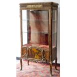 A French kingwood vitrine with marble top, the frieze decorated to centre panel with figures,