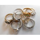 A lady's ring set three diamonds, on a gold coloured metal shank, a lady's cluster ring set