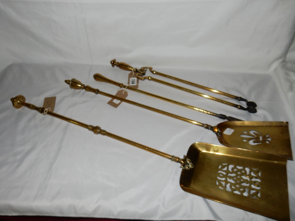 Three brass long handled fire implements