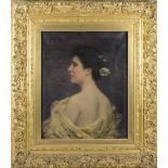 F. Le Quesne. A signed oils on canvas - Head and shoulders portrait of a lady with flowers in her