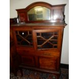 An Edwardian mahogany and satinwood crossbanded cabinet, the raised back with arched bevelled