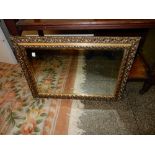 A pair of Edwardian mahogany framed dining chairs with pierced centre splats, stuff over seats, on