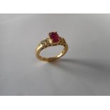 A lady's ring set centre ruby flanked to each side with stepped shoulders set three and two