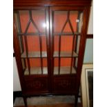 An Edwardian mahogany and satinwood inlaid display cabinet fitted two glass and panelled doors