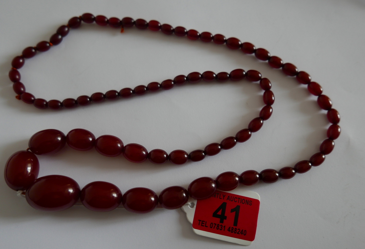 Vintage 80cm long string of Cherry Amber/Bakelite Beads - largest bead 28mm x 20mm - 59 grams weight