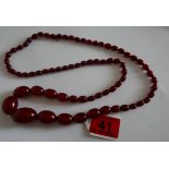 Vintage 80cm long string of Cherry Amber/Bakelite Beads - largest bead 28mm x 20mm - 59 grams weight