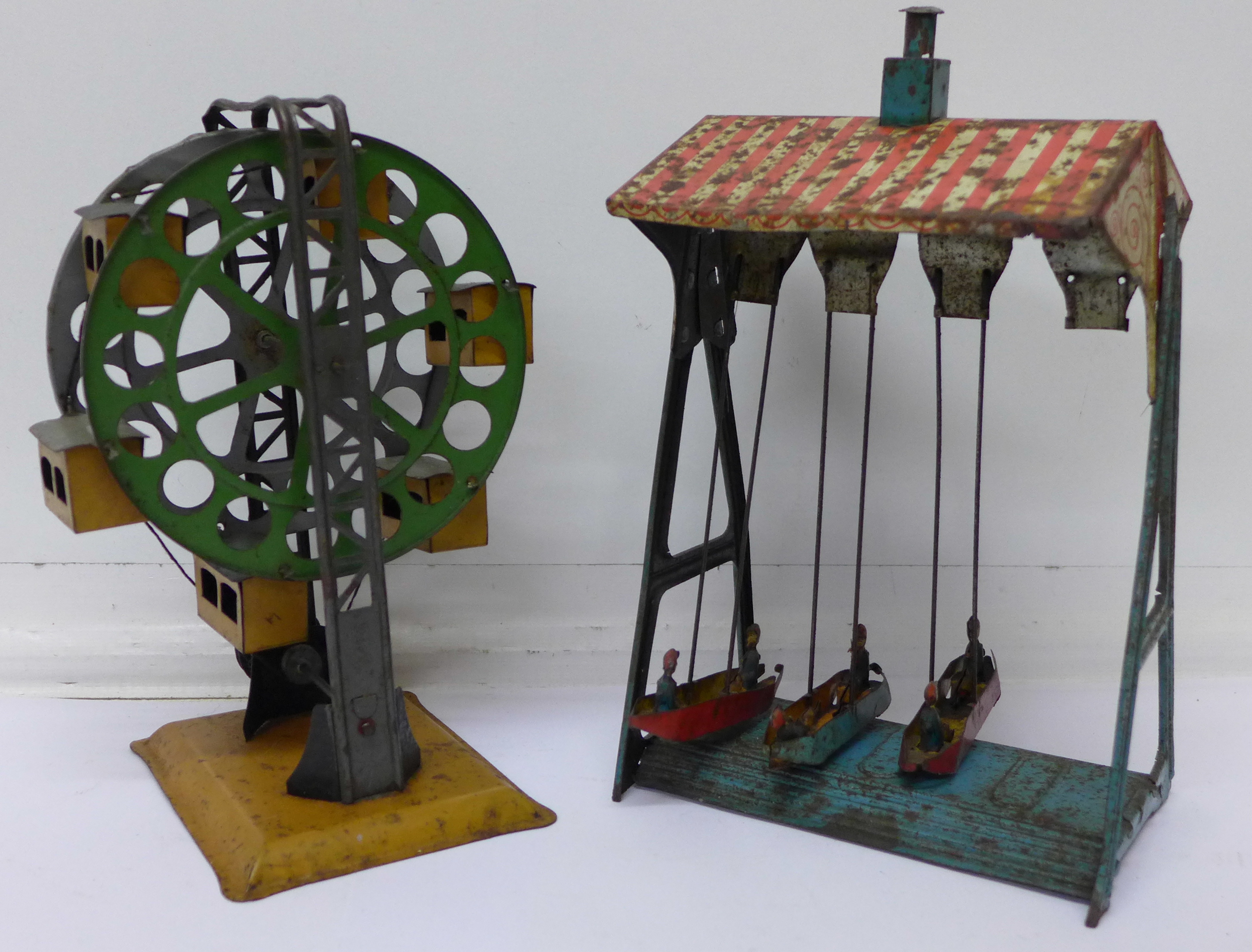 A pre-war German tin plate ferris wheel and a German fairground ride,