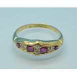 An 18ct gold, eight stone ruby and diamond ring, 3.