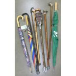 A silver mounted walking stick, umbrellas,