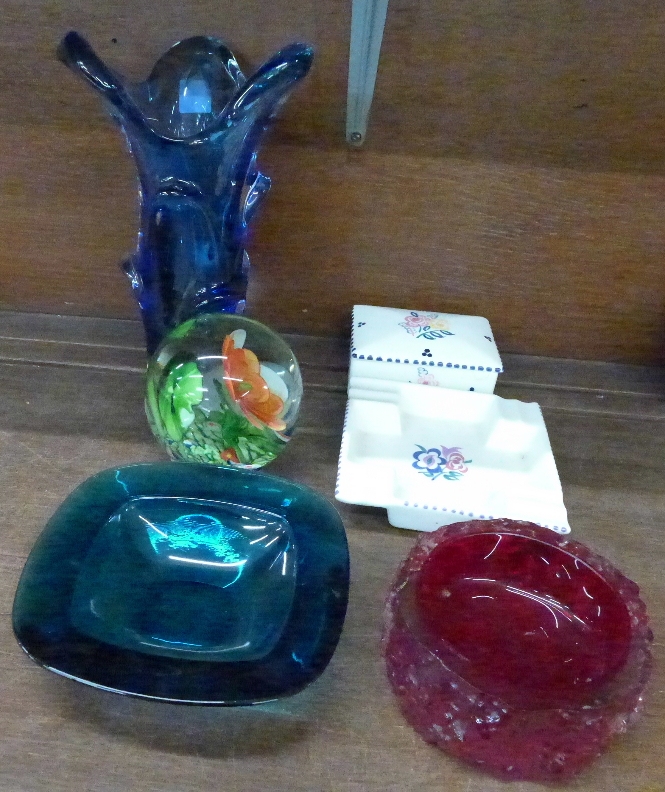 A Poole trinket box and Poole ashtray, a large glass paperweight,