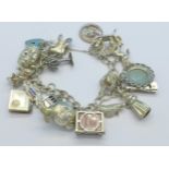 A silver charm bracelet with eighteen charms,