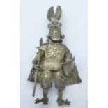 A large white metal brooch, a king or knight in battle dress,