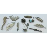 Ten brooches including a sea horse and silver