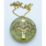 A heavy jade and gilt pendant,