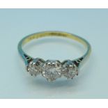 An 18ct gold, platinum and three stone diamond ring, total diamond weight 0.5 carats, 2.