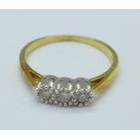 An 18ct gold and three stone diamond ring, 3.