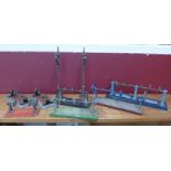 A collection of engine pulleys, model rail lamp posts, etc.