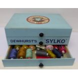 A Dewhurst's Sylko three drawer cotton reel cabinet with contents