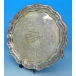 A white metal salver with long service inscription to centre,