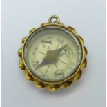 A hallmarked 9ct gold compass charm