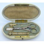 A 19th Century sewing set in an ivory case, possibly French,