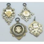 Four silver fobs, two gold fronted, 50.