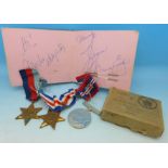 Three WWII medals and an autograph book
