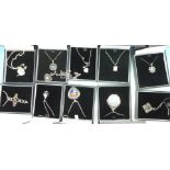 Eleven silver pendants and chains
