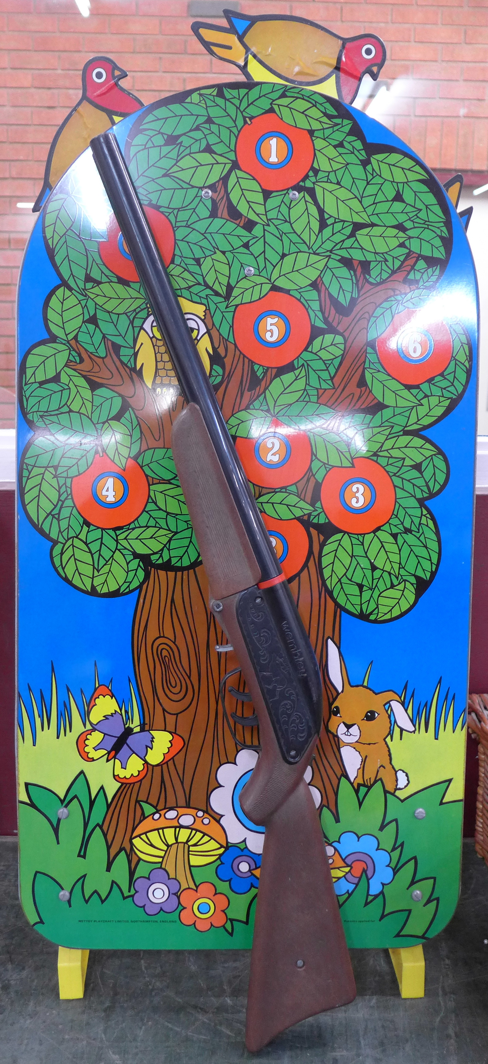 A Mettoy Playcraft toy rifle and tin plate target with revolving birds