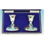 A pair of silver candlesticks in fitted case